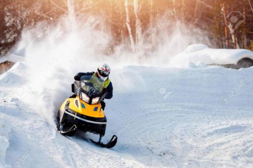 Snowmobile. Snowmobile races in the snow. Concept winter sports, racers.